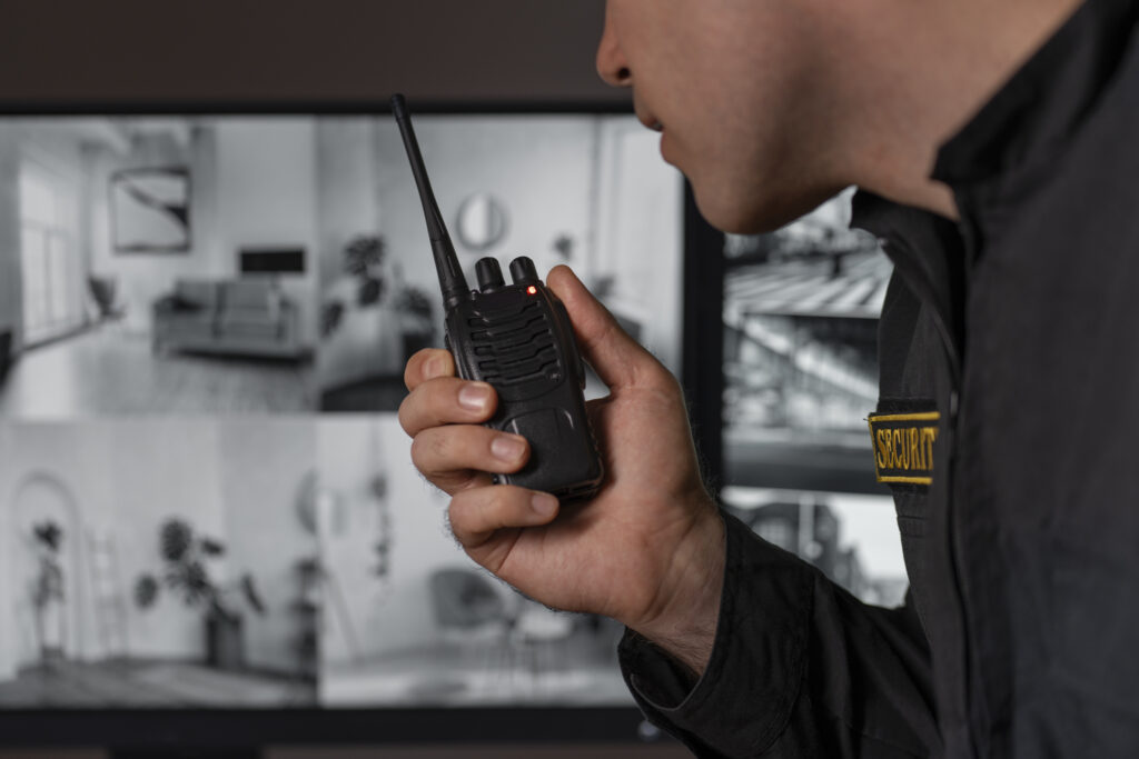 portrait male security guard with radio station camera screens